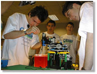 Four students build with LEGOs
